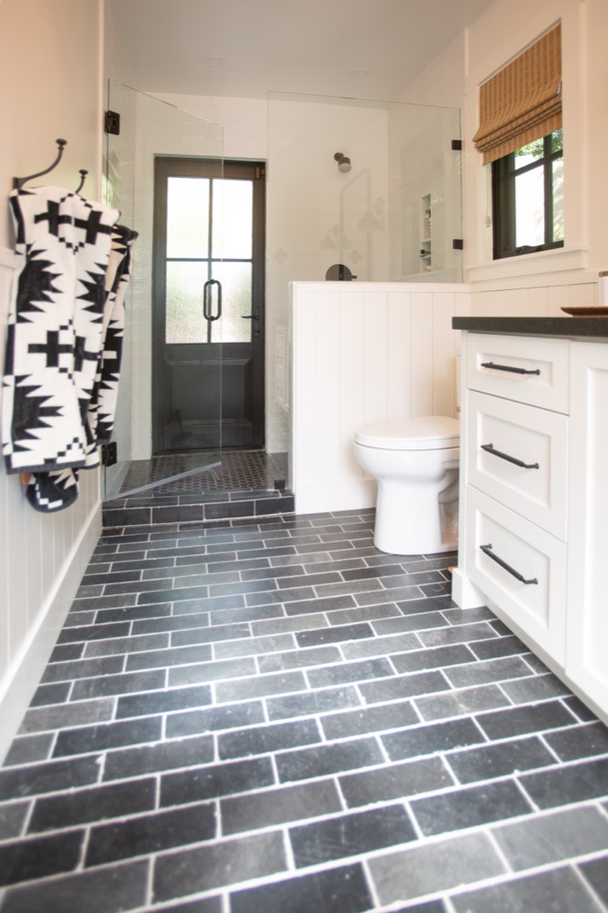 Pool house bath with slate floor and black hardware