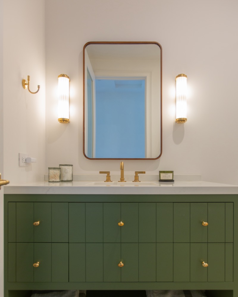 Sage green vanity with brass fittings