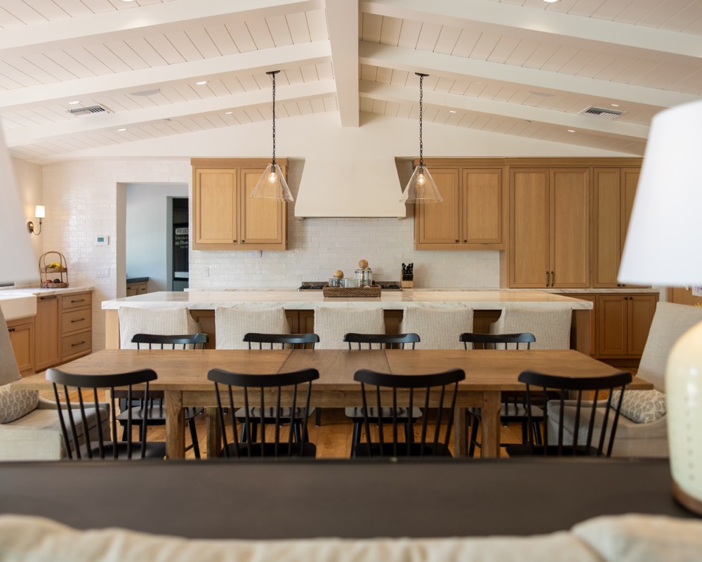 Dining room with white beamed ceiling and oak table