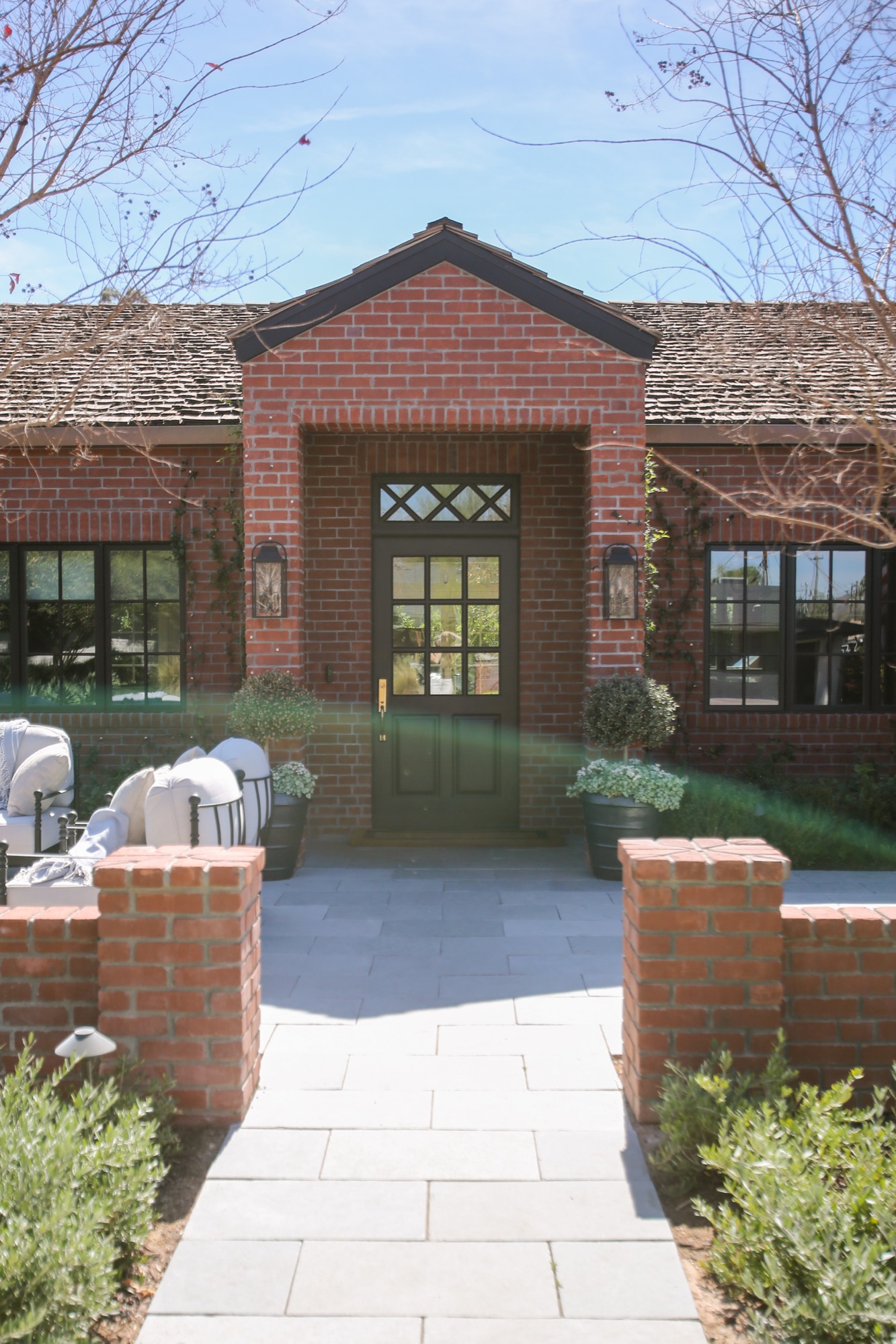 Red brick entry with a black steel door