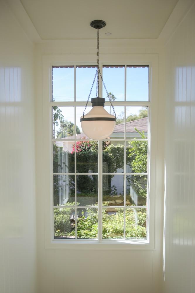 Window and lantern in a white hallway, State Ave