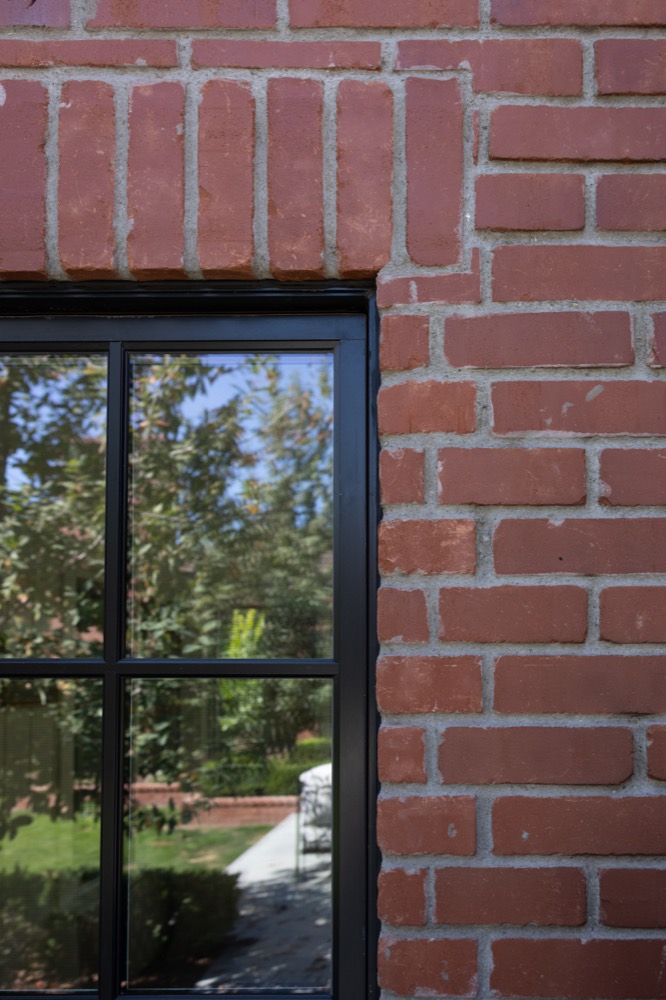 Brick corner with a black steel window, State Ave